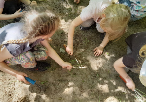 Dzieci pielą ogródek z chwastów