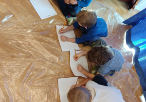 Dzieci rysują ołówkiem.
