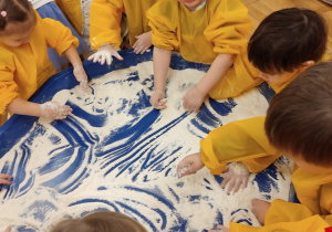 Dzieci malują mąką i kaszą manną.