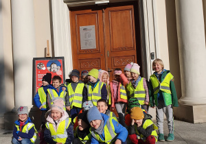 Dzieci pozują do zdjęcia przy wejściu do Muzeum Niepodległości.