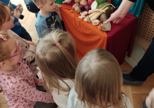 Dzieci oglądają wystawę warzyw.