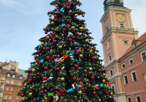 Dzieci oglądają choinkę przy Zamku Królewskim.